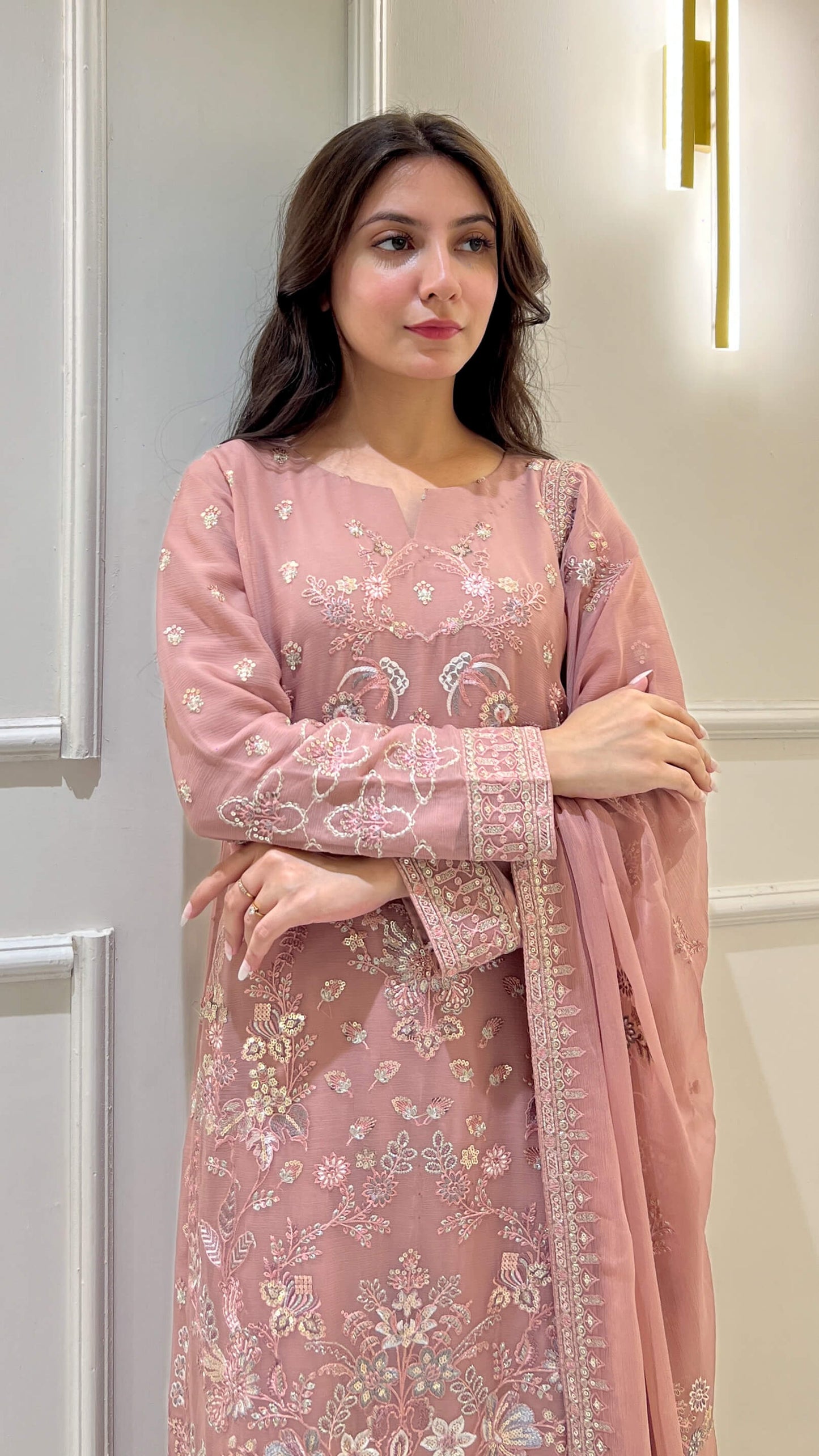 Close-up of floral embroidery on peach shirt