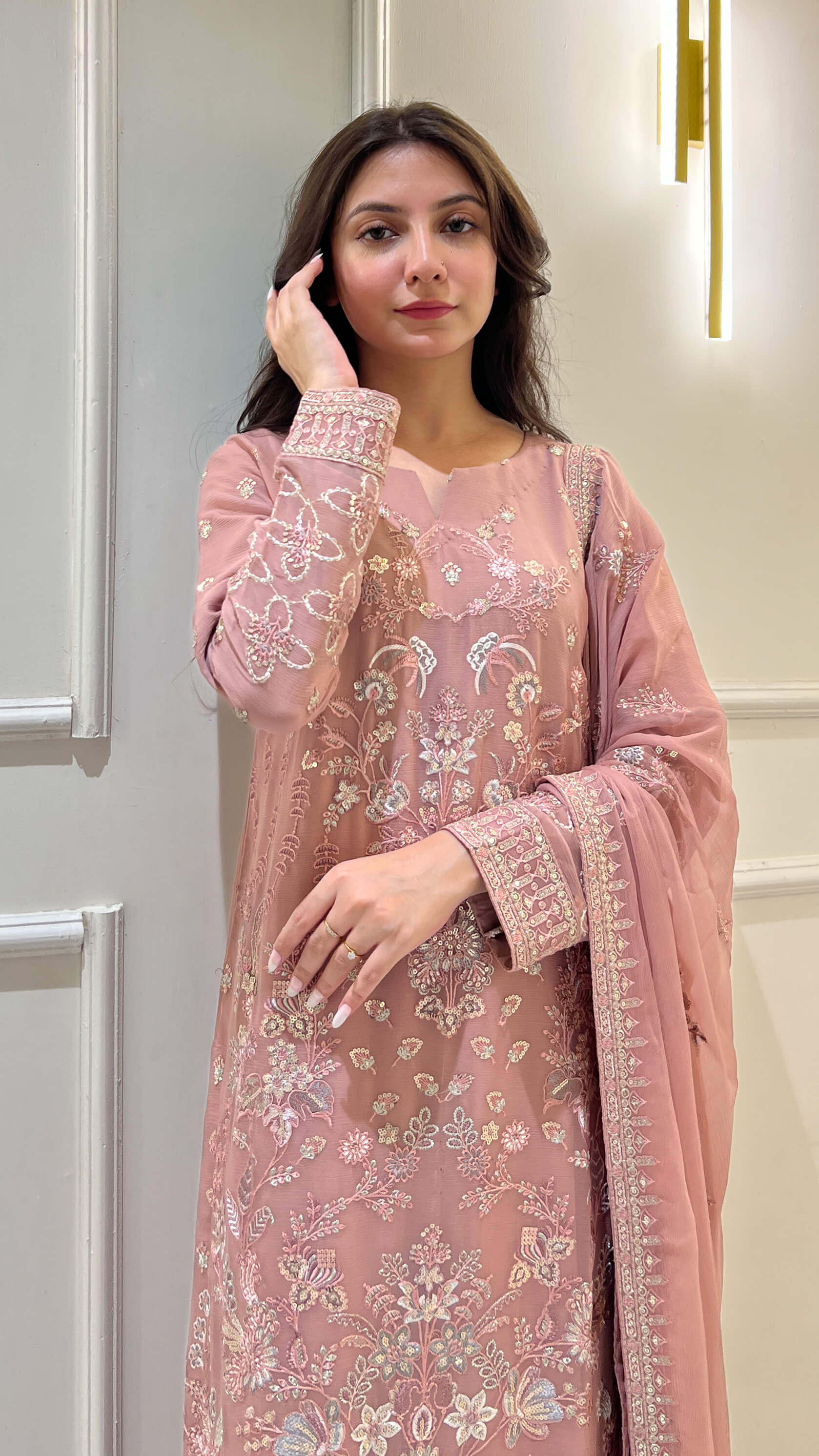 Woman in peach embroidered chiffon shalwar kameez with matching dupatta Video