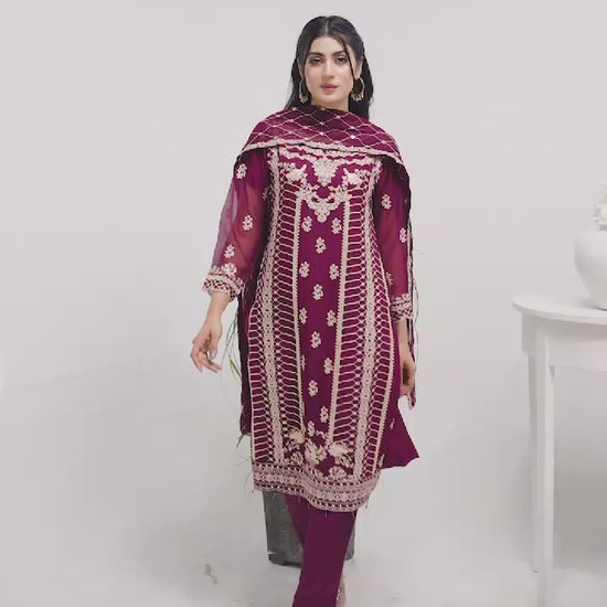 Woman wearing a magenta embroidered chiffon salwar kameez video